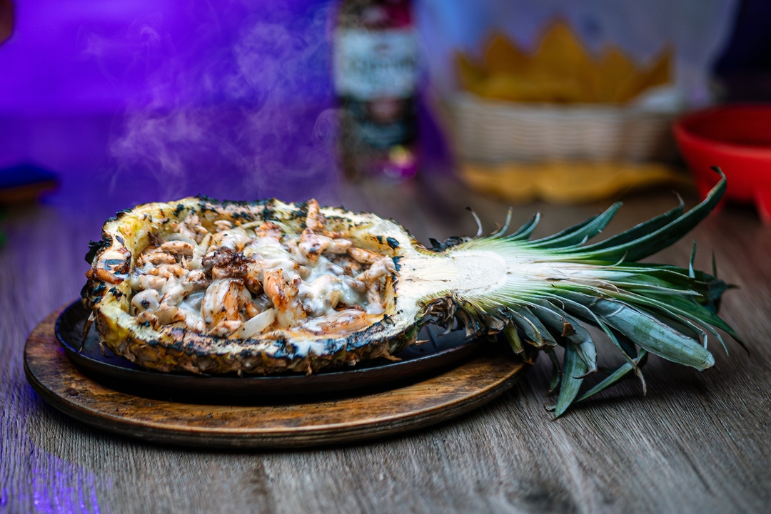 Mexican meats plated on a sliced pineapple at El Salto Mexican Restaurant.