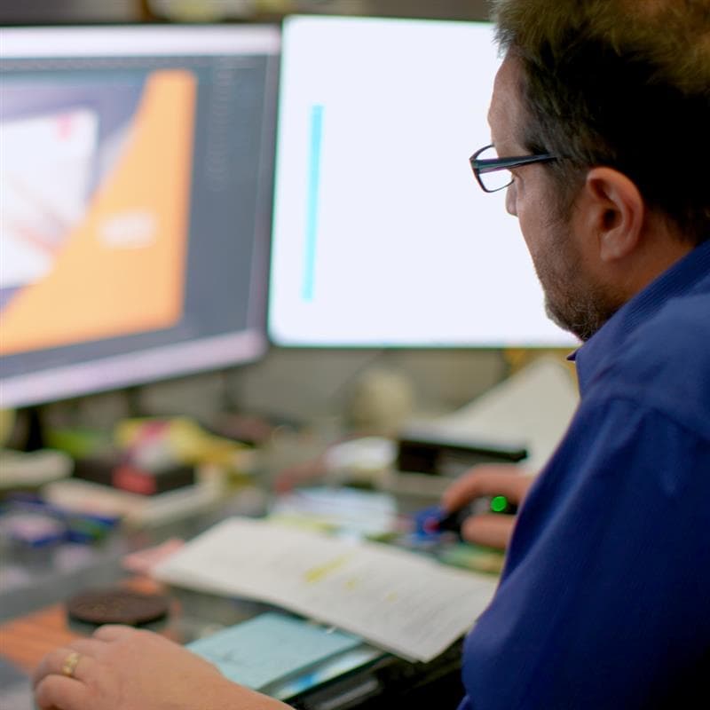 Todd Stanton at his computer working on a video edit