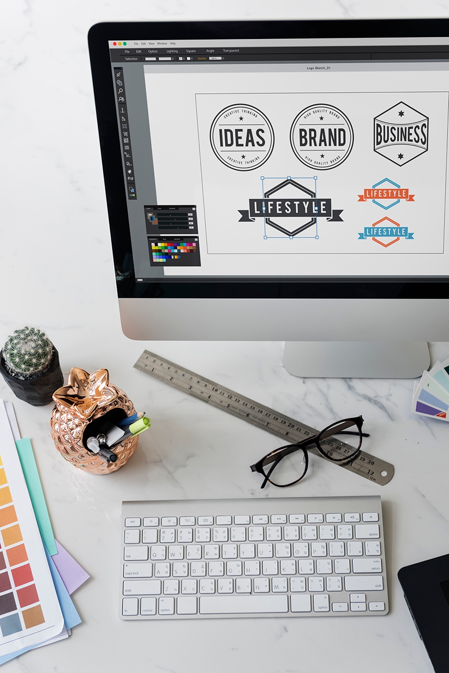 Partial showing of a desktop computer screen with different logo design options