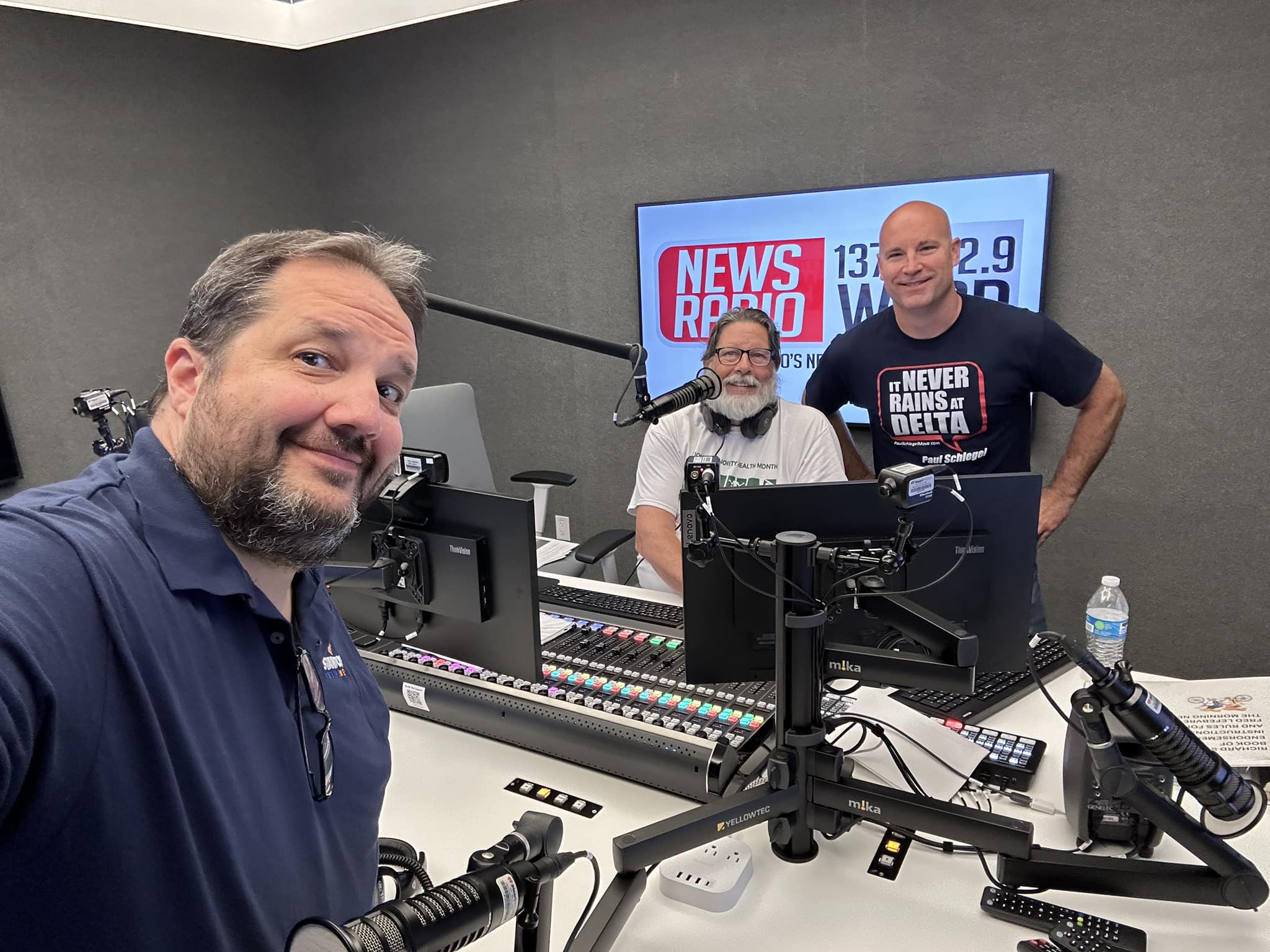 A member of Stanton Creative Media, along with the client, and news radio personality appearing in the radio studio to promote the film.